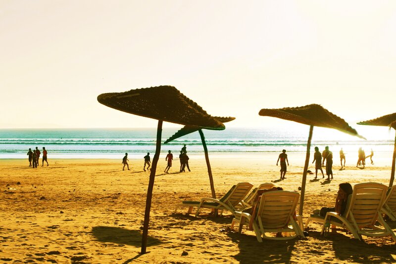 Beach at sunset with people