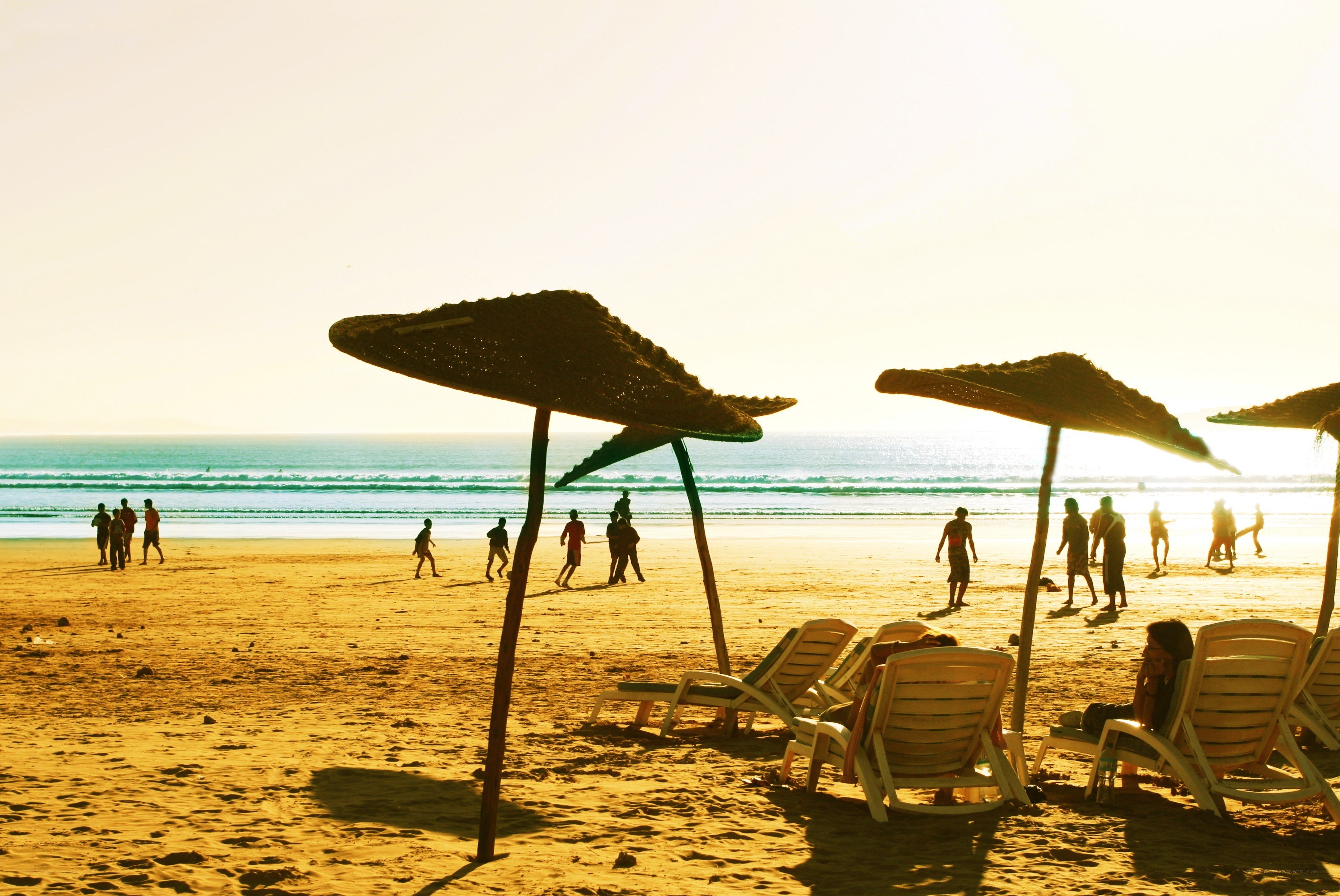 Beach at sunset with people