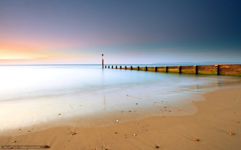 Beach at sunset with pier