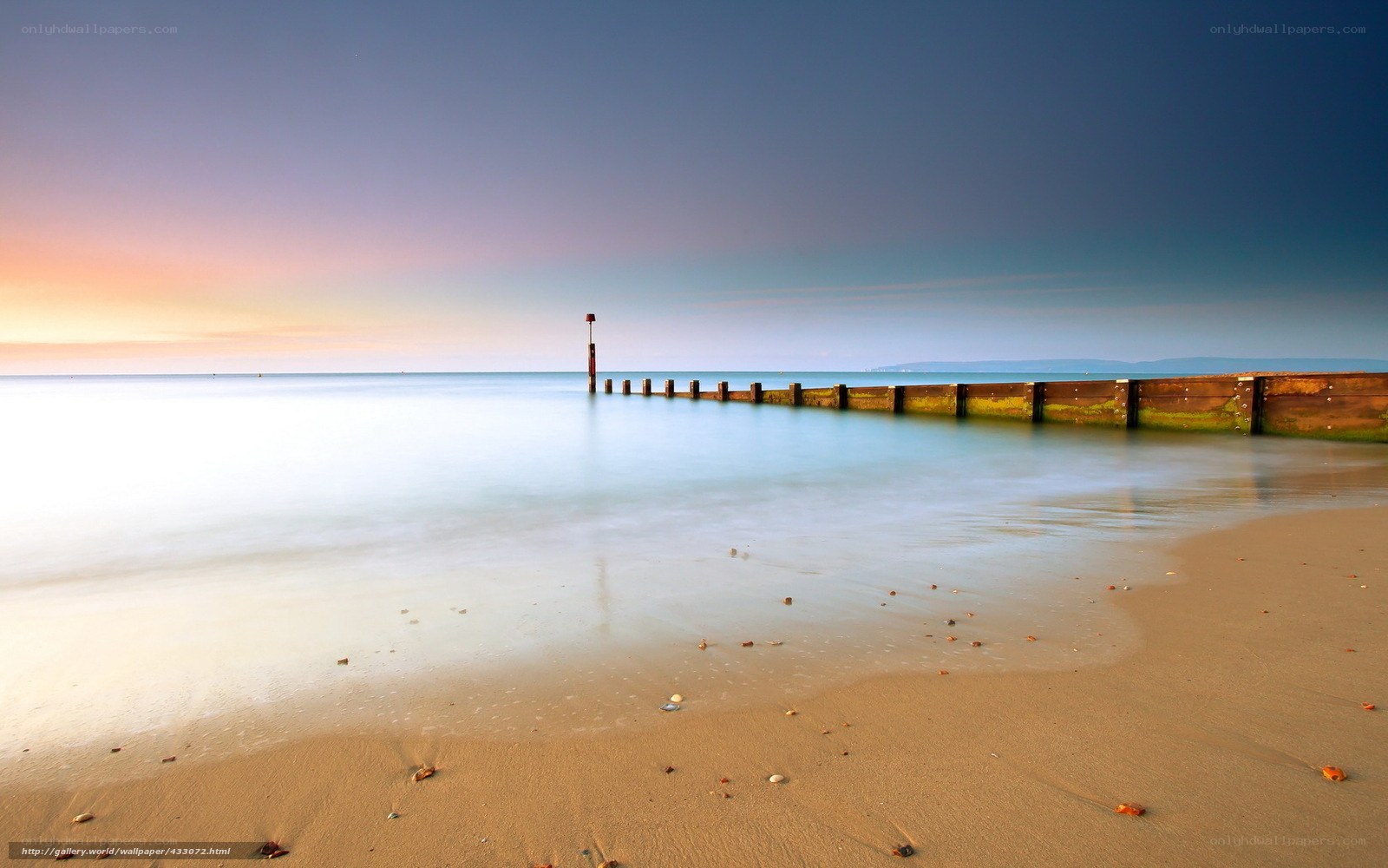 Beach at sunset with pier