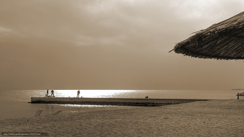 Beach at sunset with pier