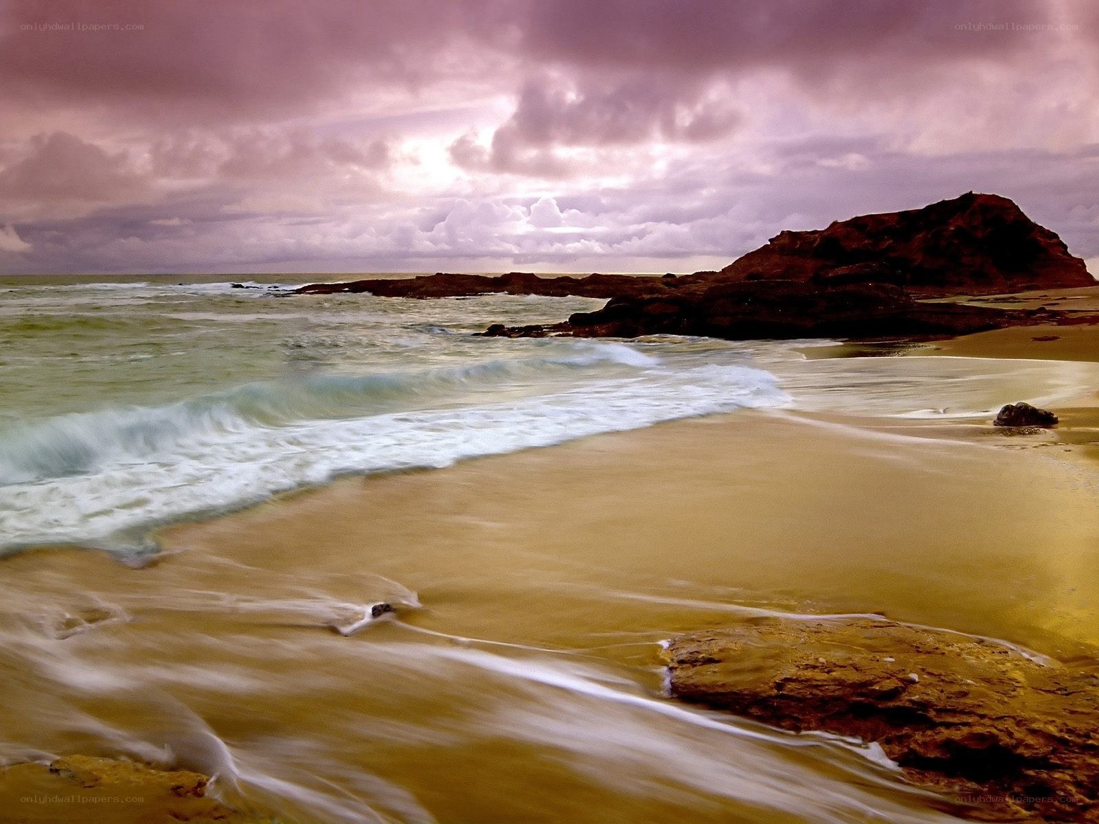 Beach at sunset with purple sky