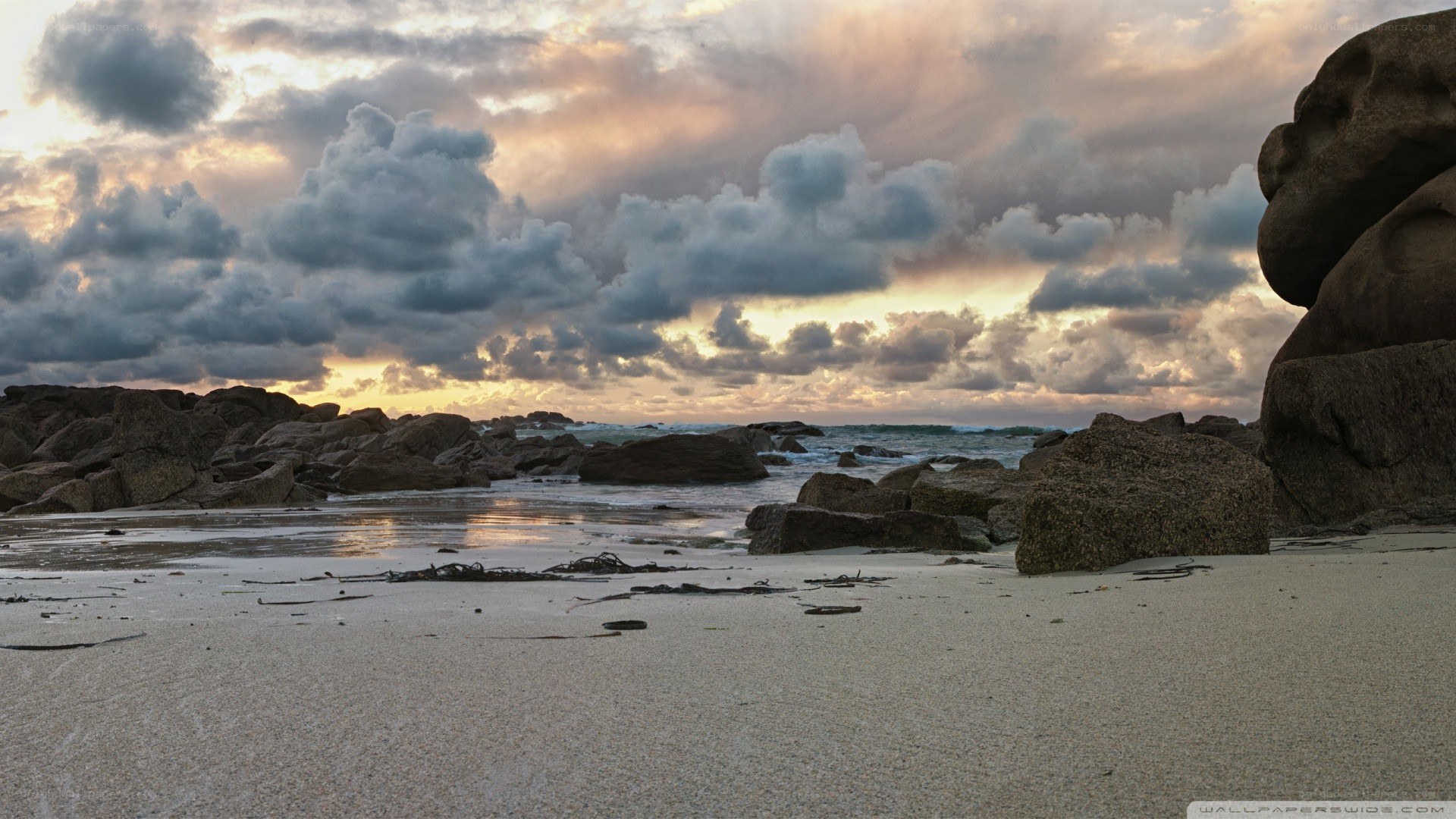 Beach at sunset with rocks