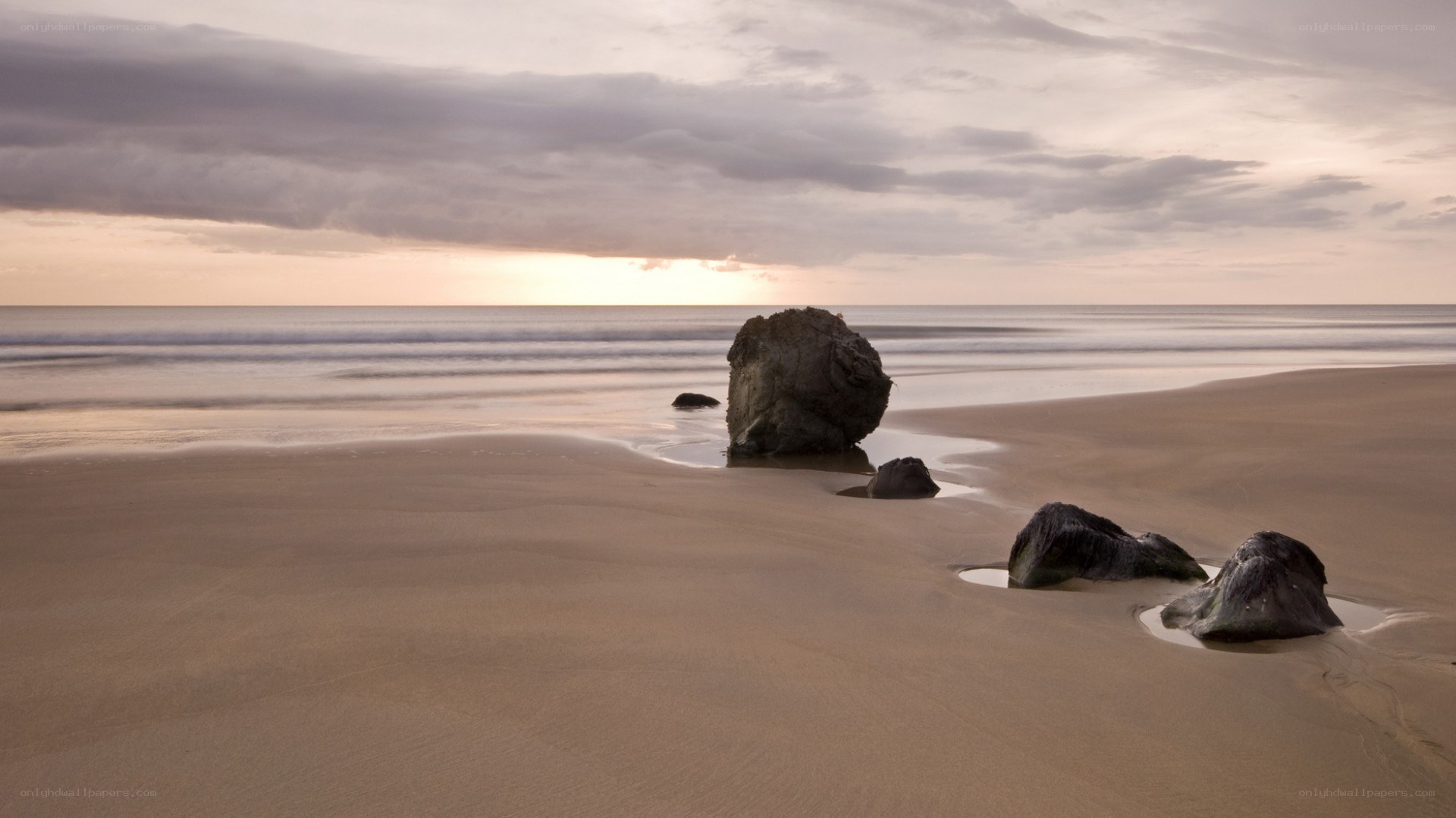 Beach at sunset with rocks