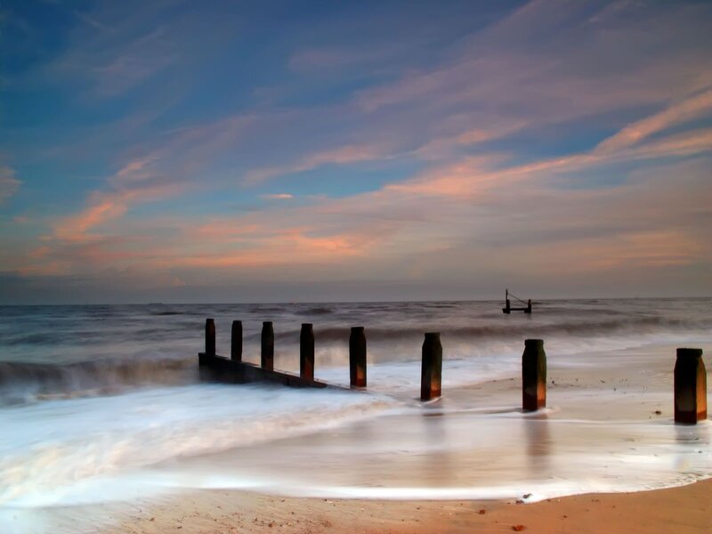 Beach at sunset with sea wall