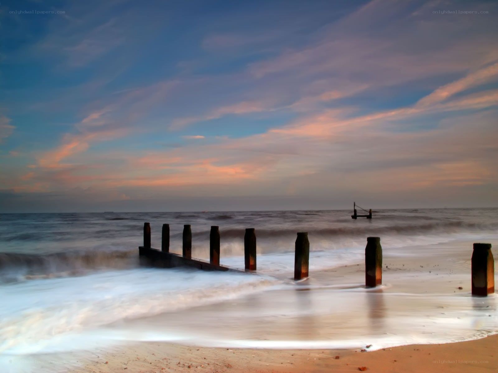 Beach at sunset with sea wall