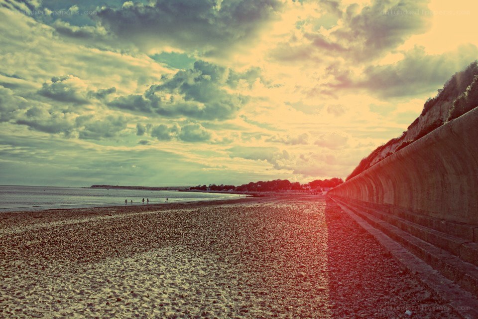 Beach at sunset with sea wall