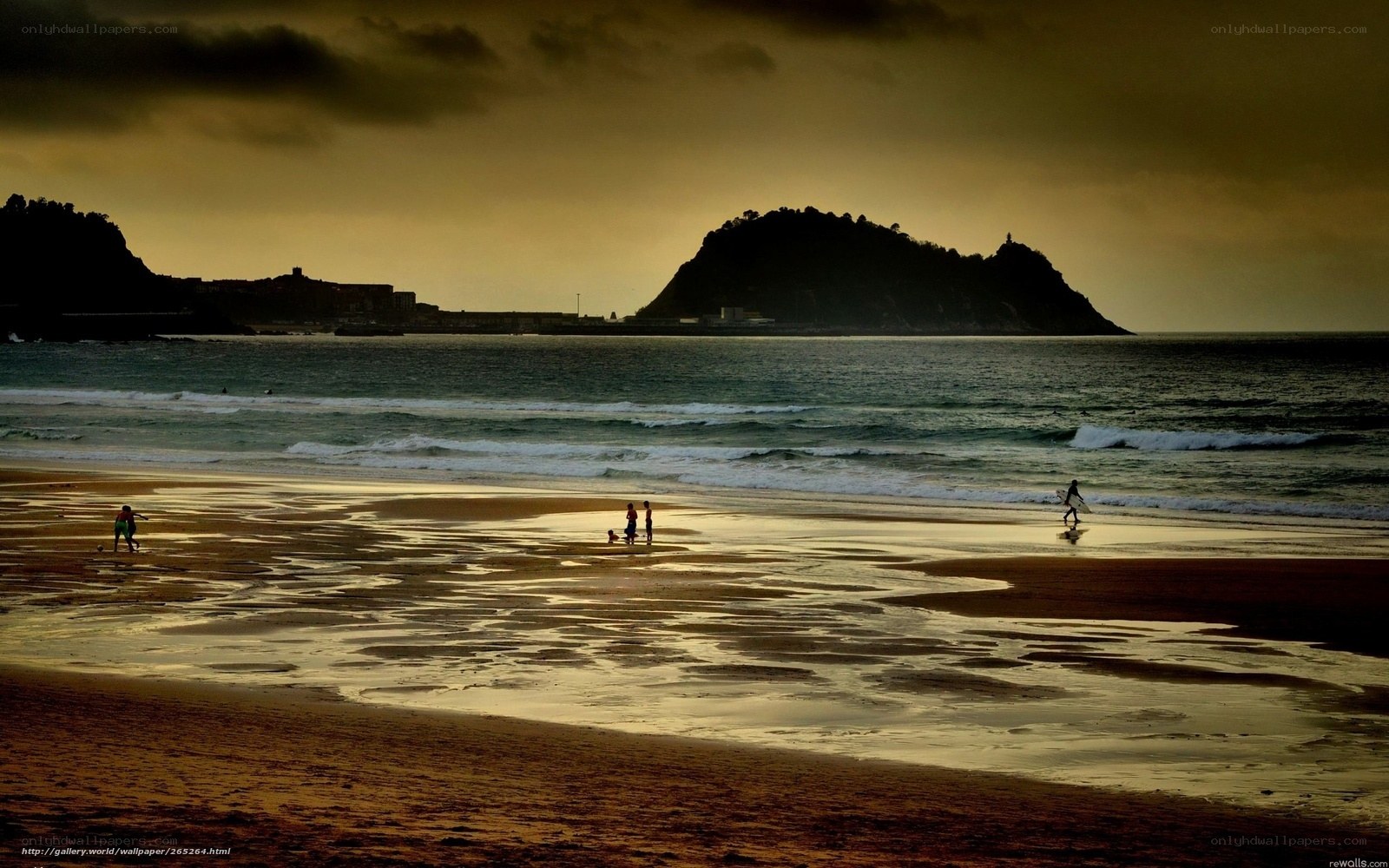 Beach at sunset with silhouettes