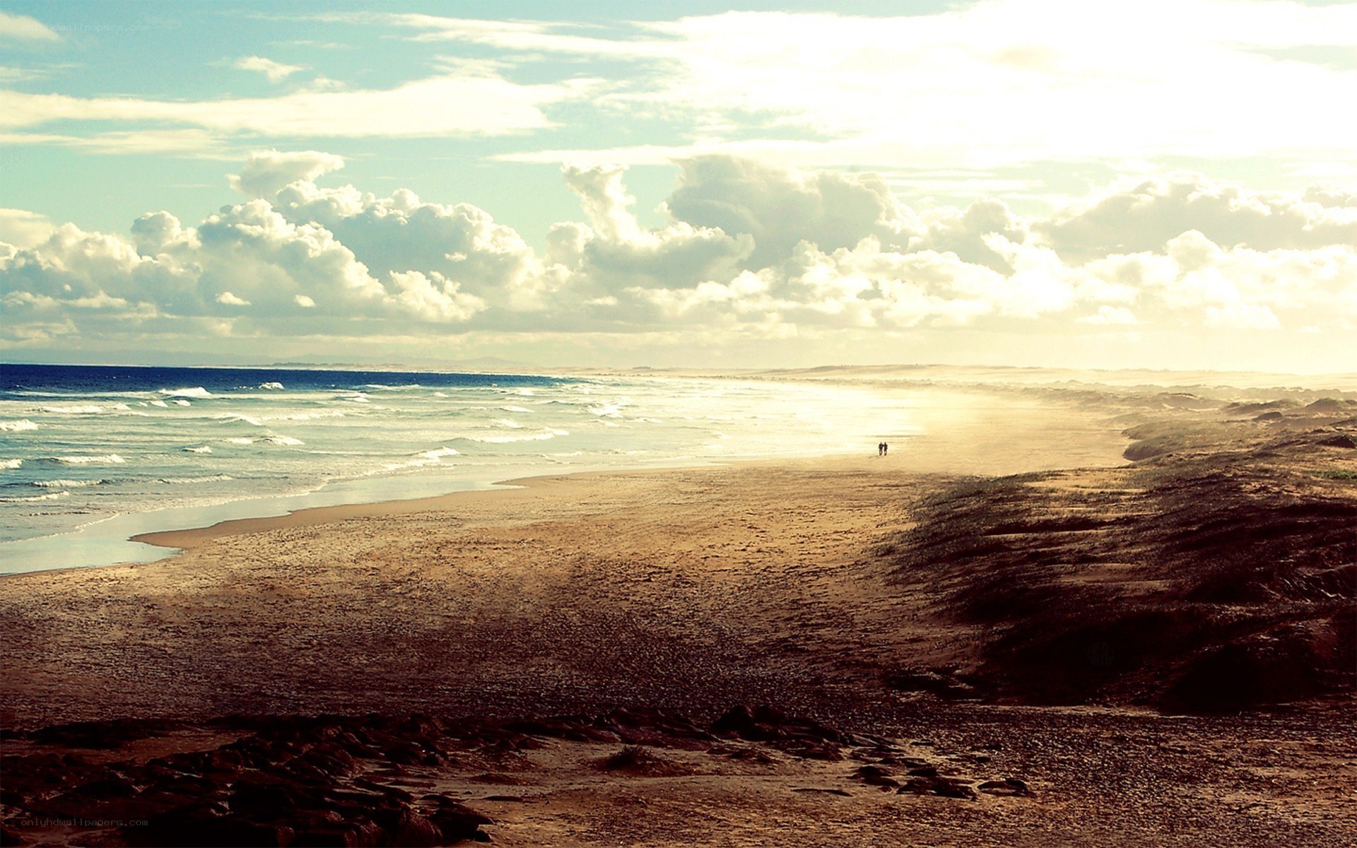 beach at sunset with two people