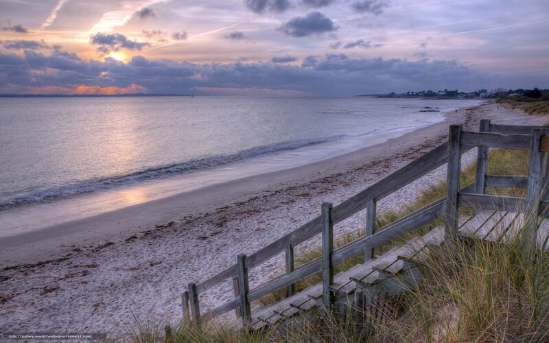 Beach at sunset with wooden stairs