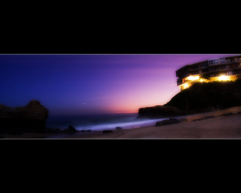 Beach at twilight with building