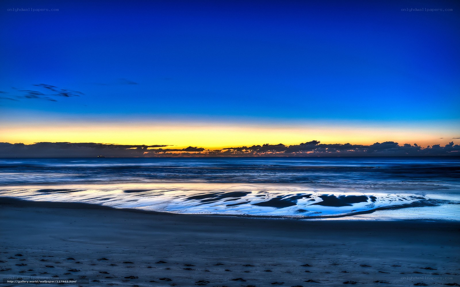 Beach at twilight with vibrant sky