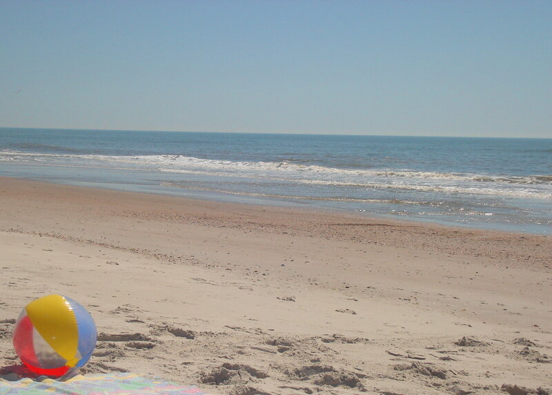 Beach ball on sandy shore