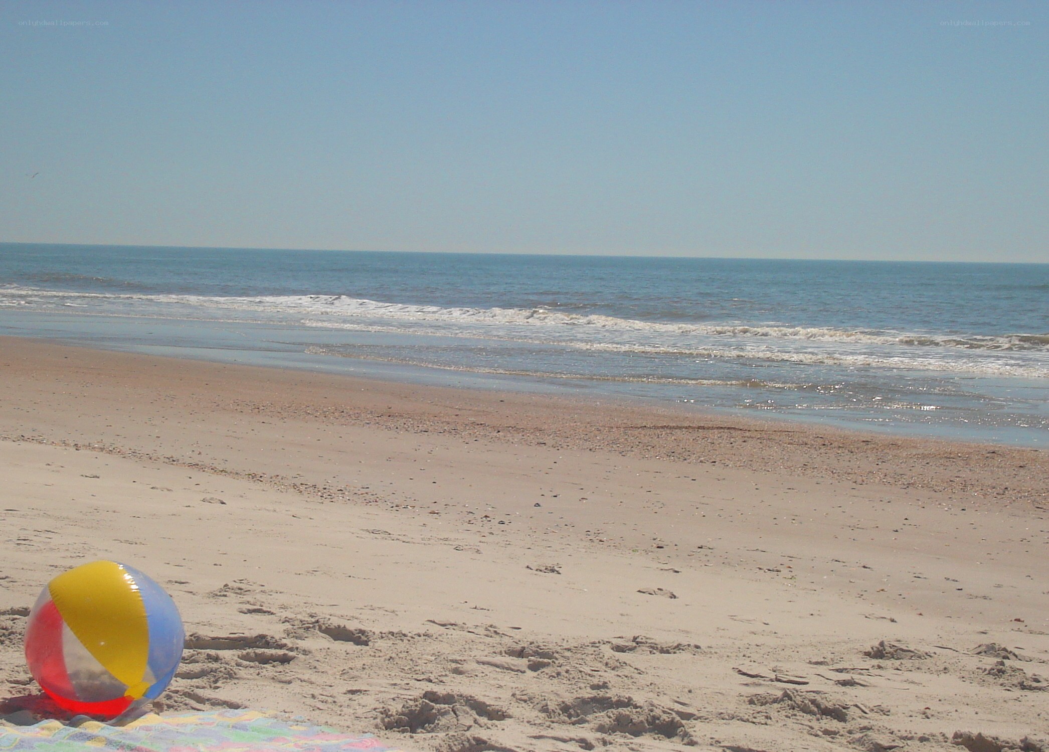 Beach ball on sandy shore