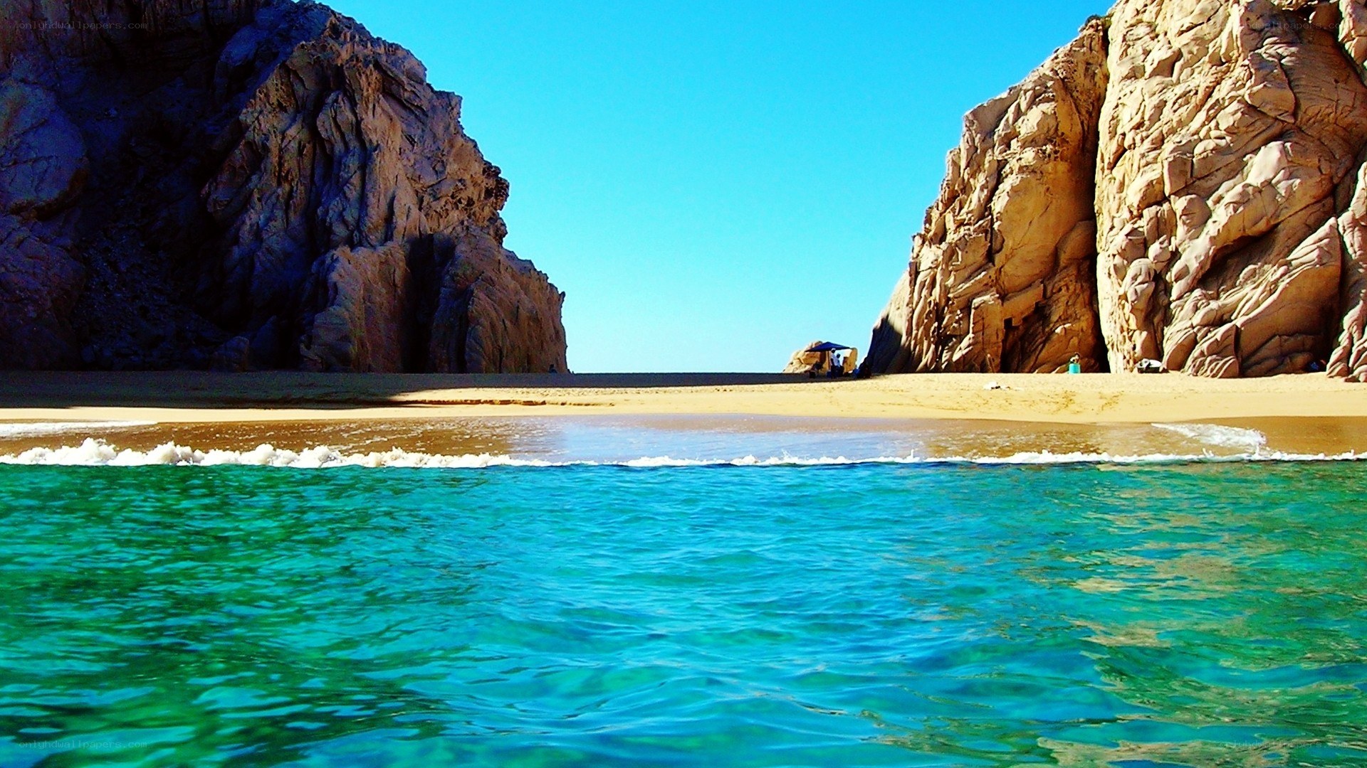 beach between rocky cliffs