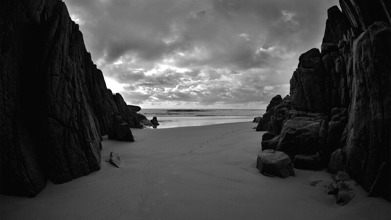Beach Between Rocky Cliffs — Black