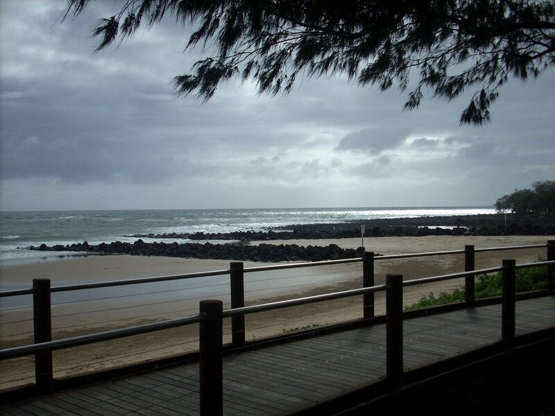 Beach boardwalk under cloudy sky