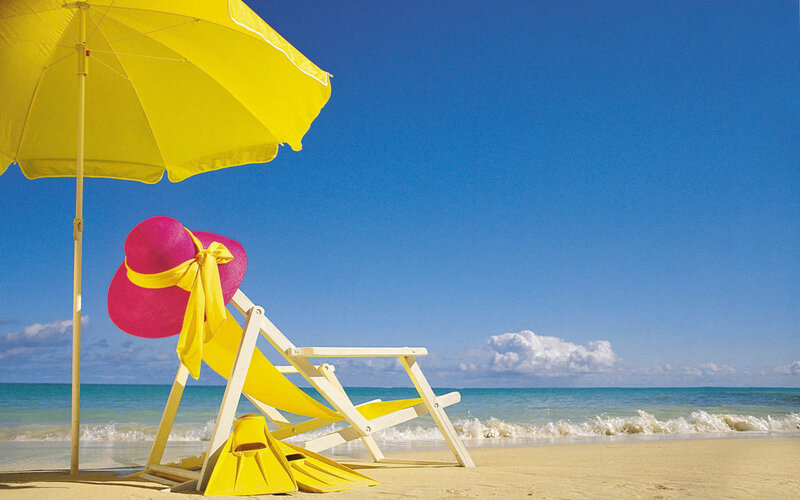 Beach chair under yellow umbrella