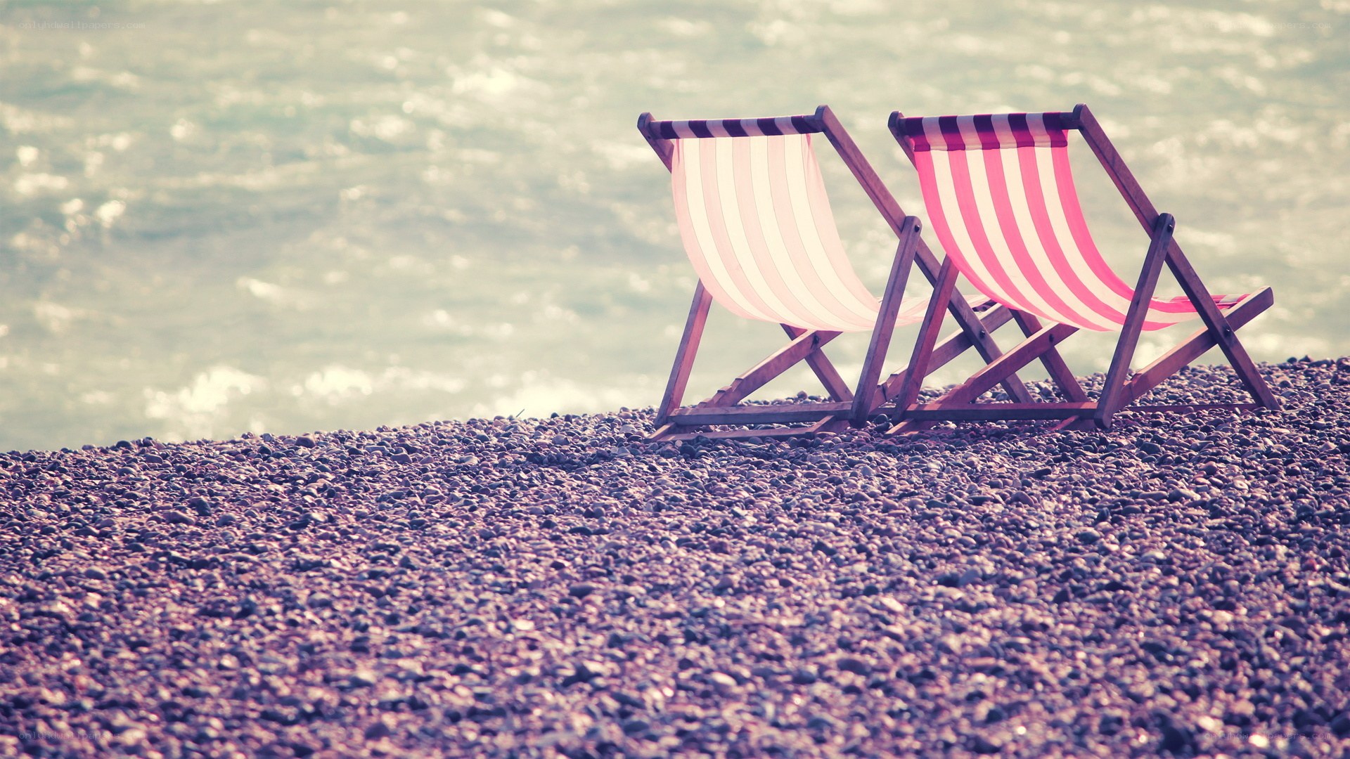 Beach chairs on pebble shore