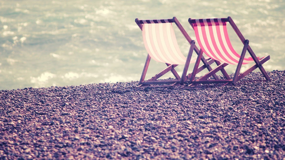 Beach chairs on pebble shore