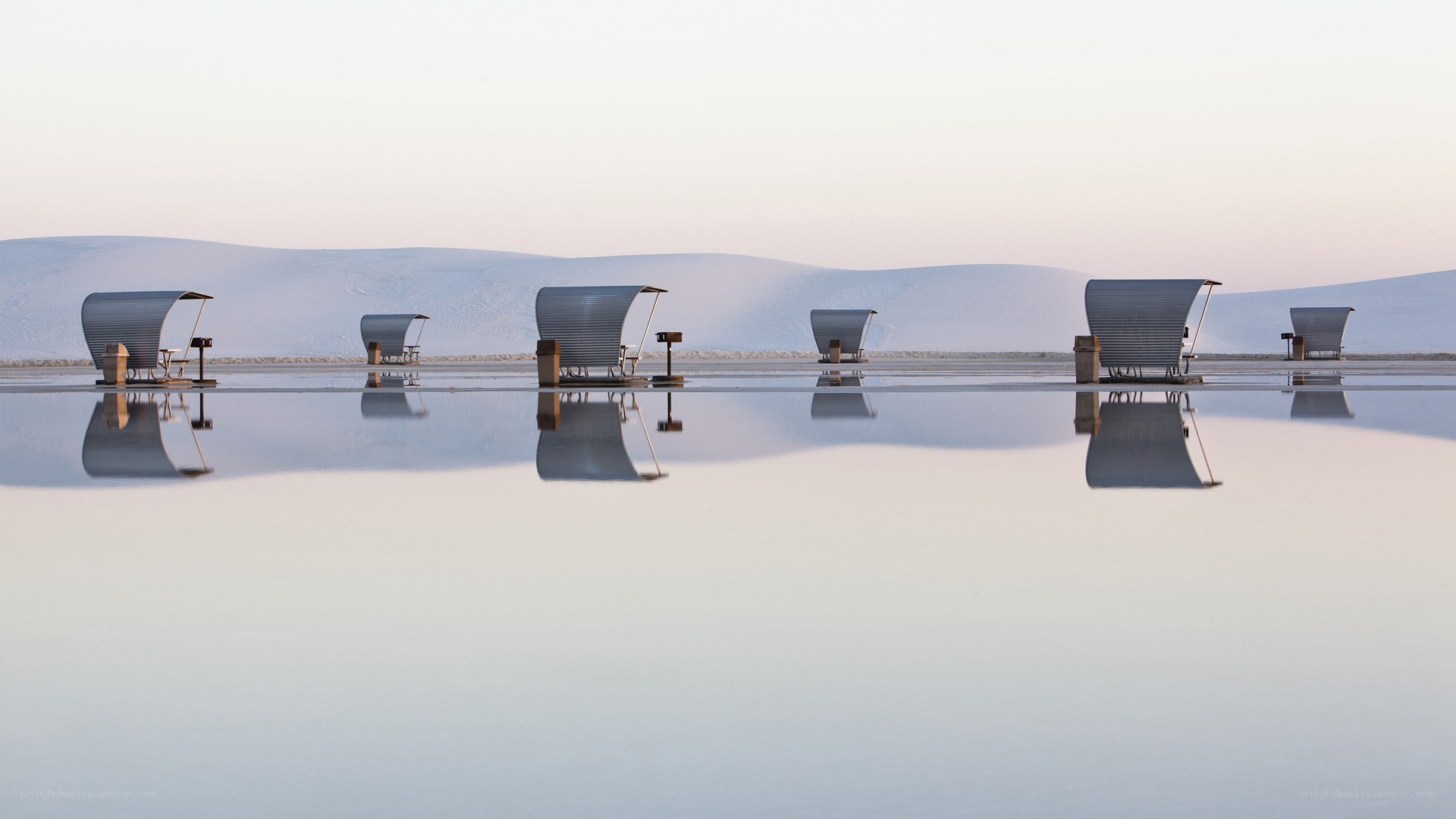 Beach chairs on reflective water