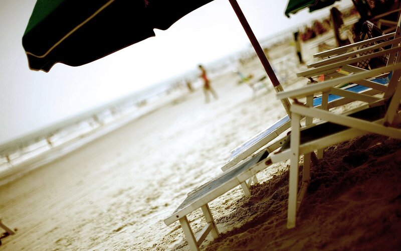 Beach chairs under an umbrella