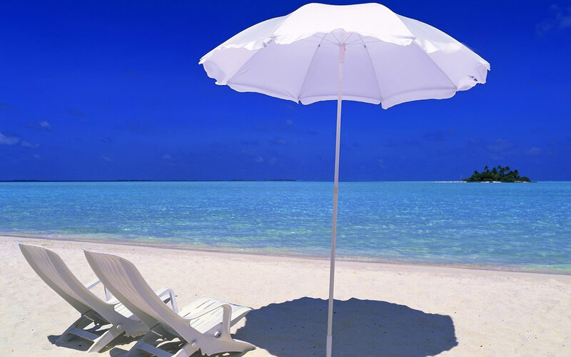 Beach chairs under umbrella