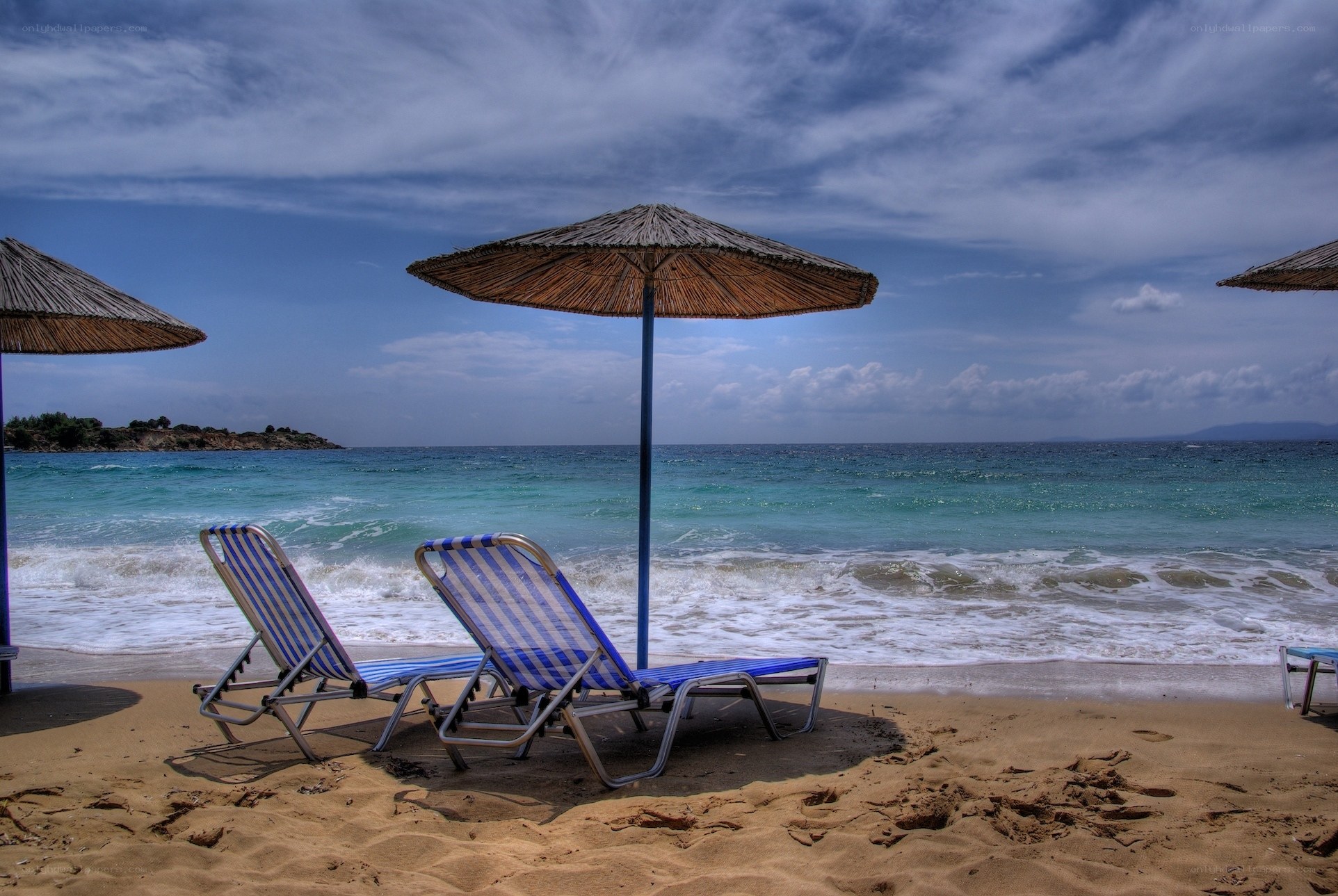 Beach chairs under umbrellas