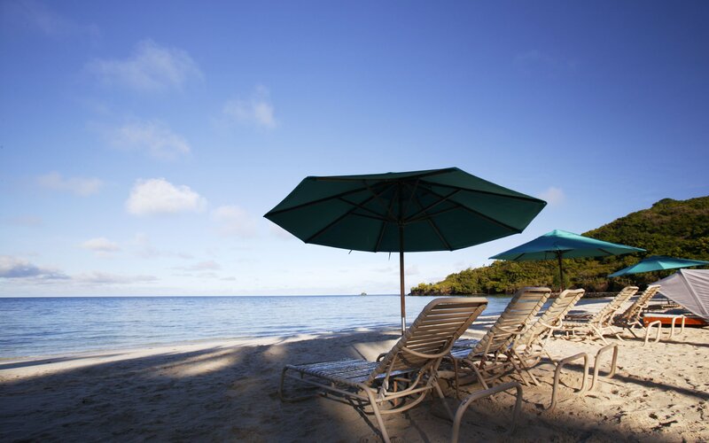 Beach chairs under umbrellas