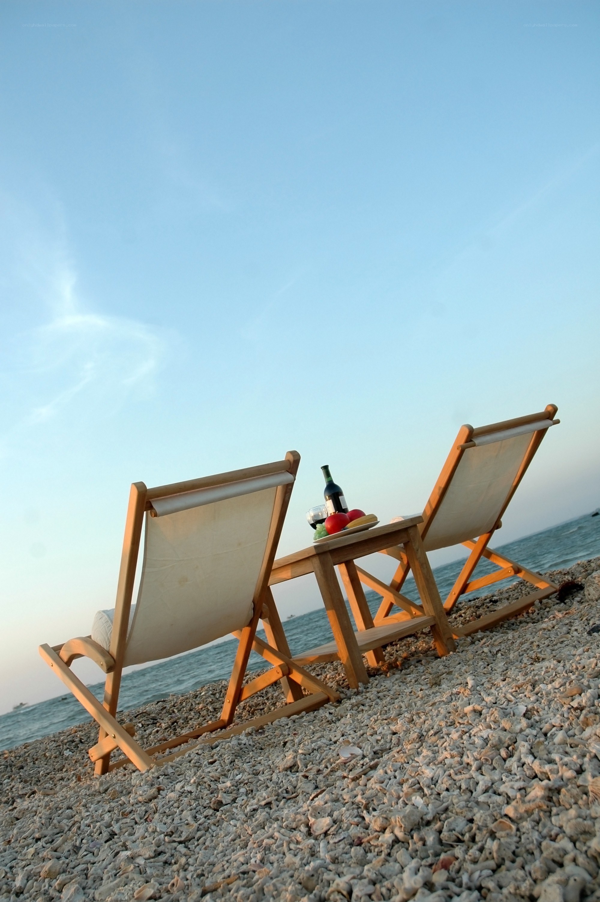 Beach chairs with wine and fruit
