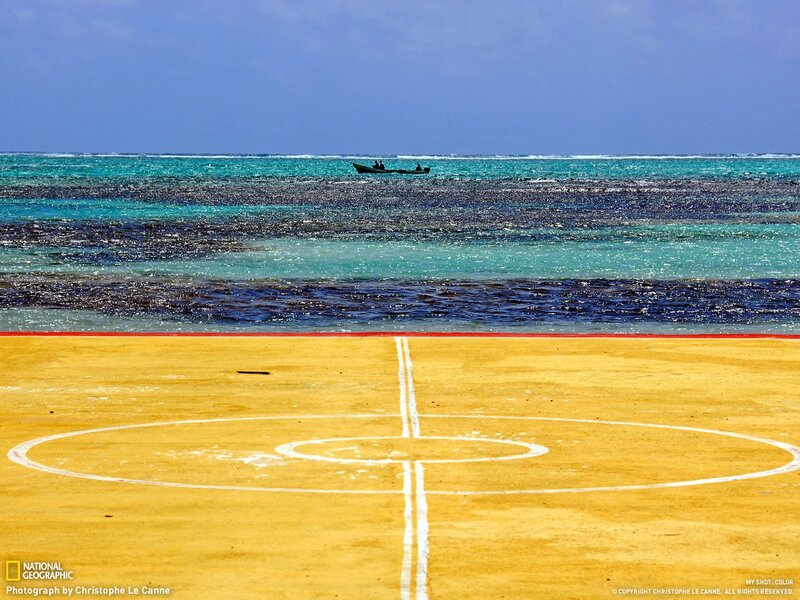 Beach court with boat in distance