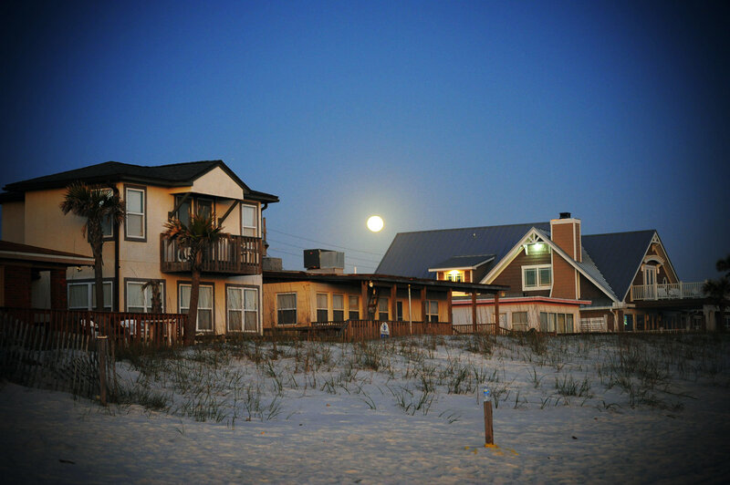 Beach houses under moonlight