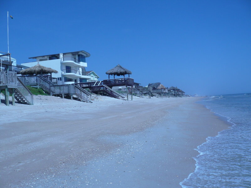Beach houses with thatched umbrellas