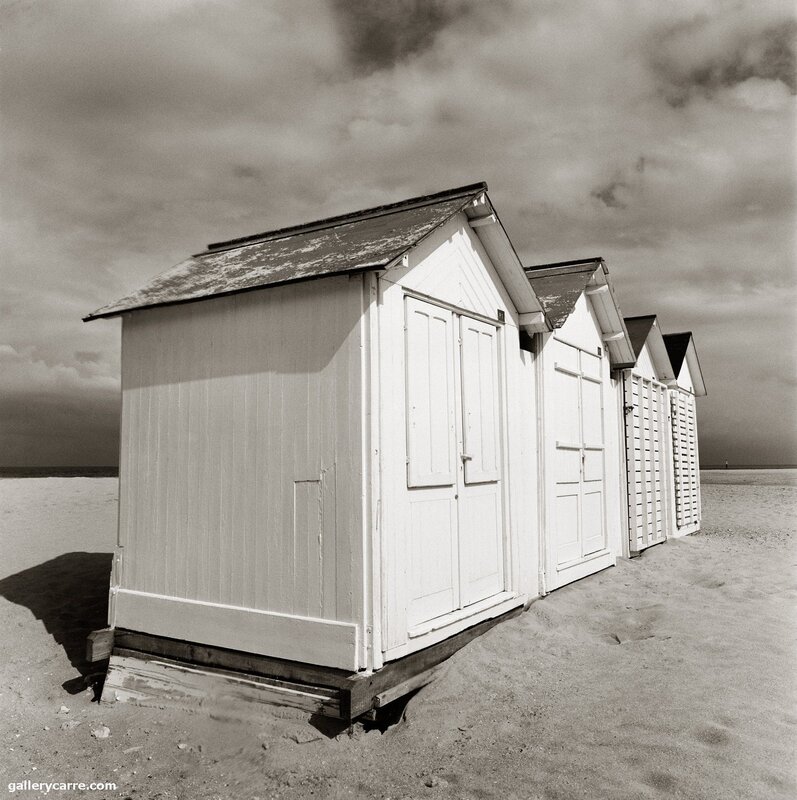 beach huts on a cloudy day