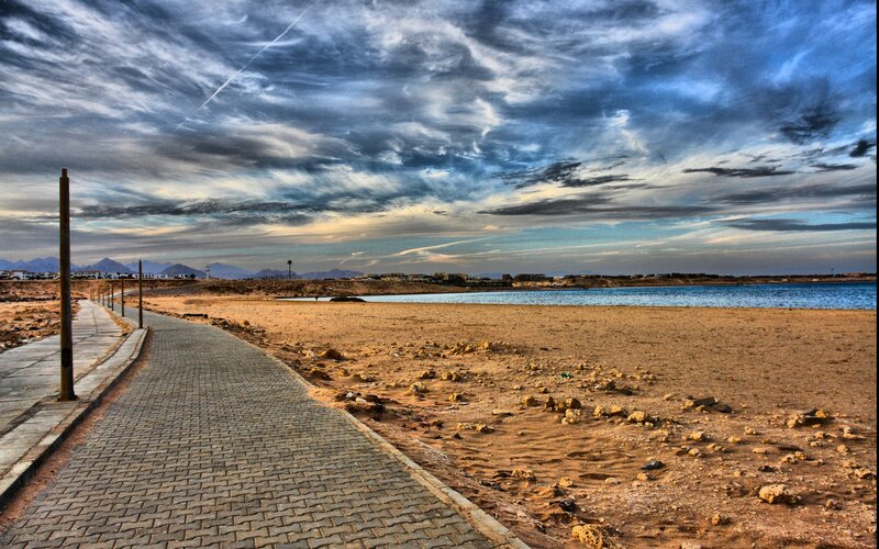 Beach path under cloudy sky