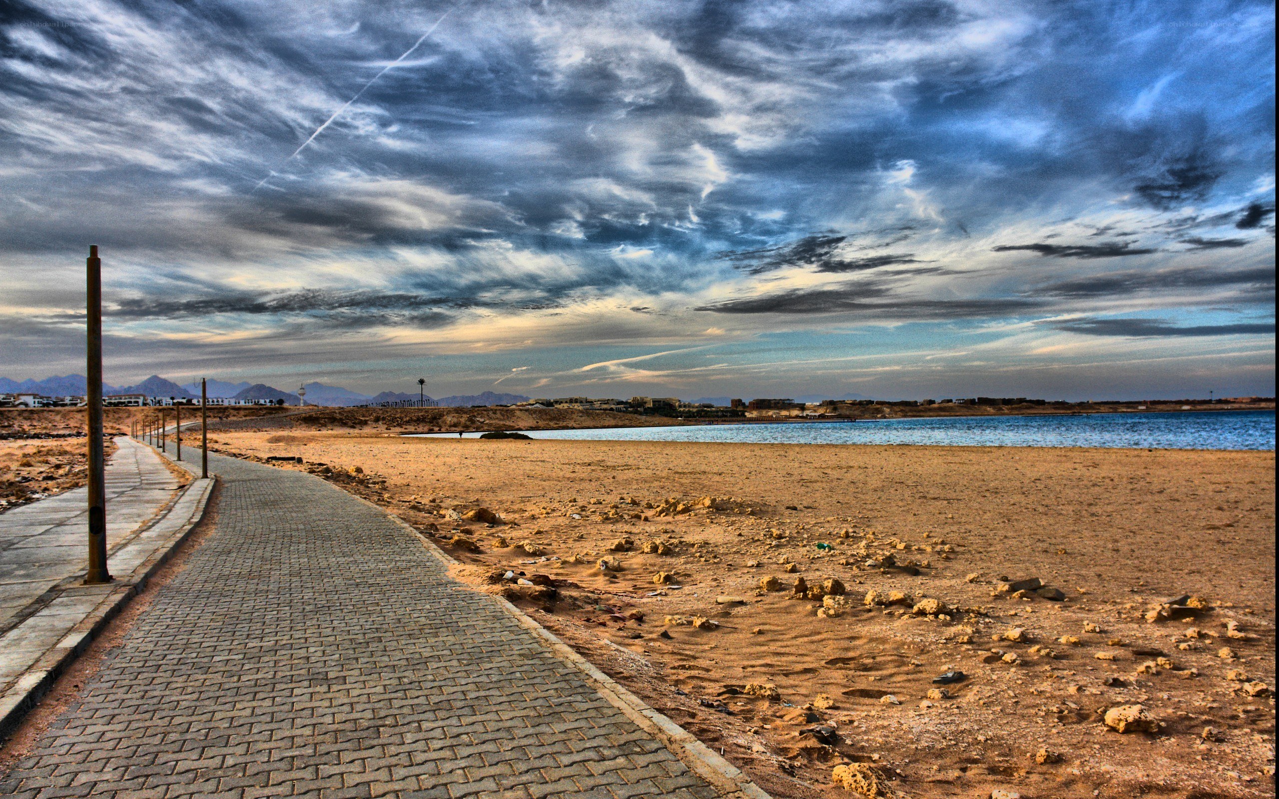 Beach path under cloudy sky