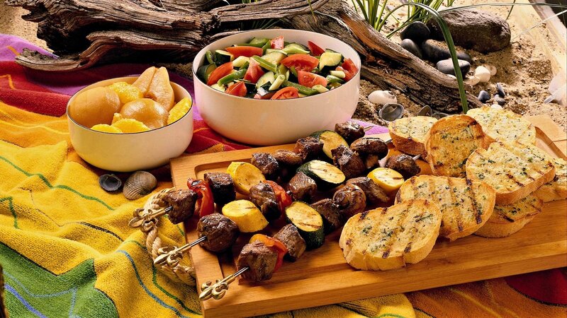 Beach picnic with skewers and salad