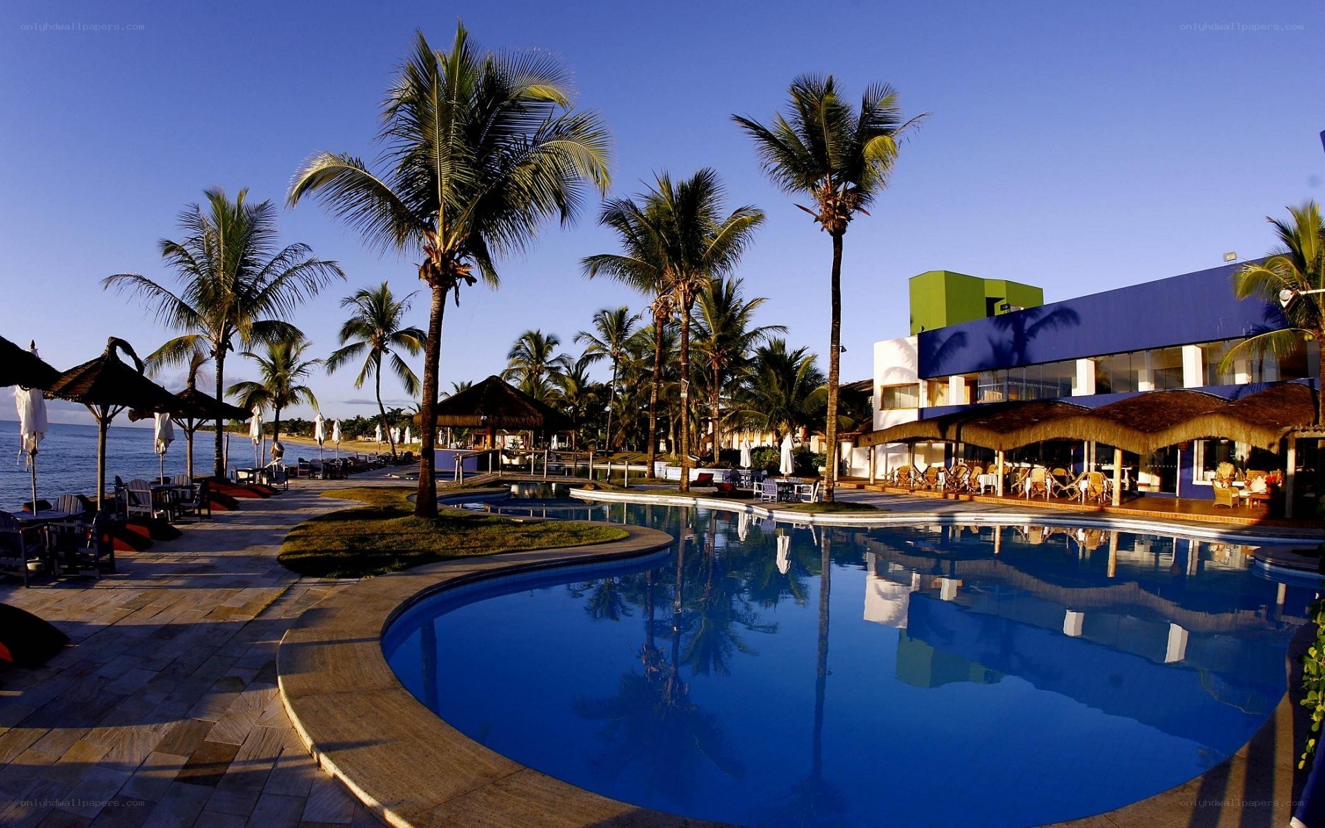Beach resort with pool and palm trees
