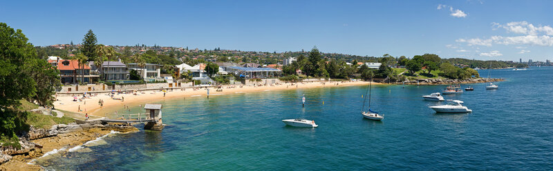 beach scene with boats and houses