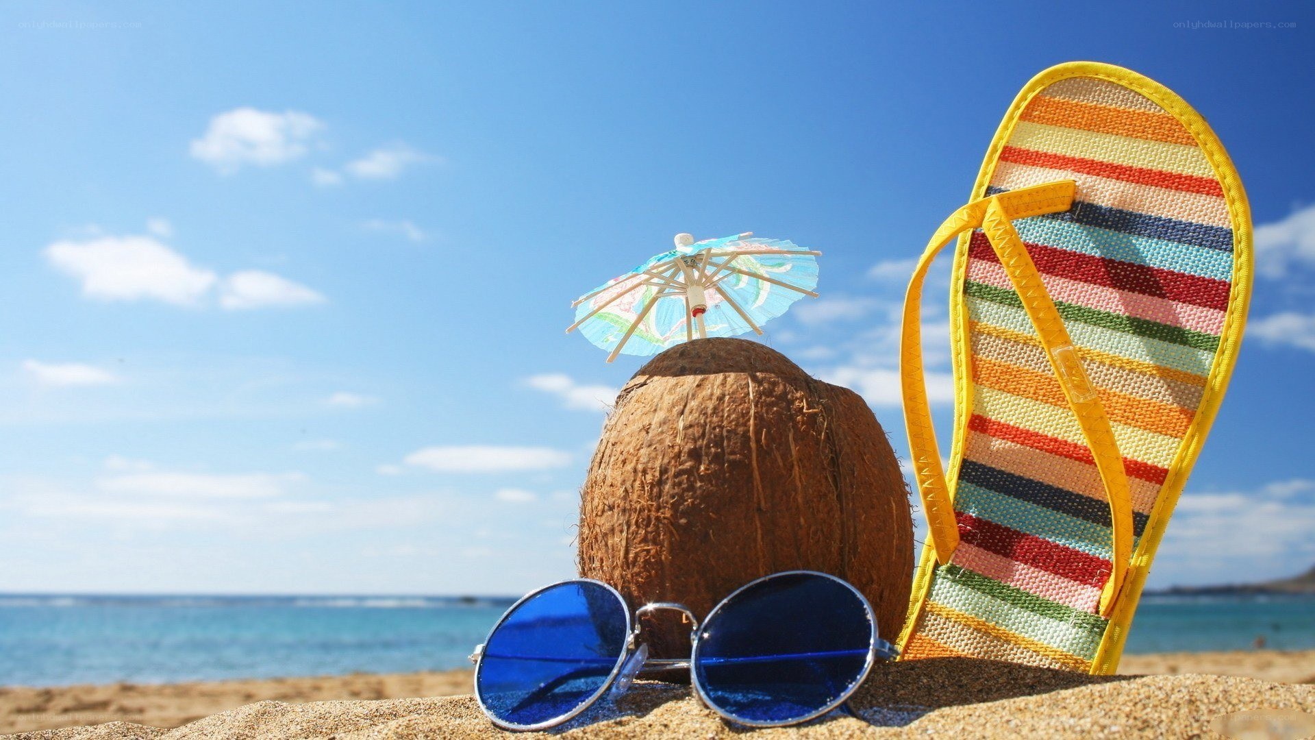 Beach scene with coconut and flip-flops