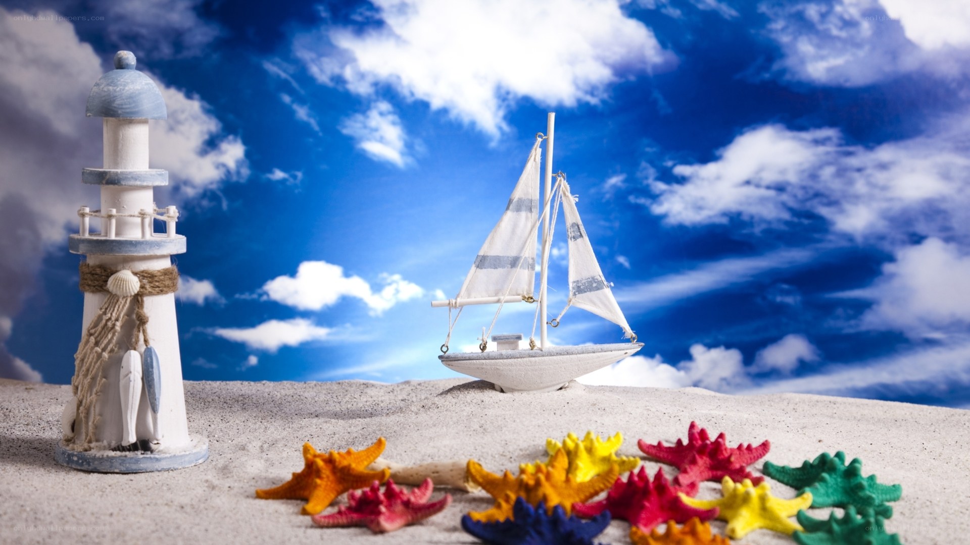 Beach scene with lighthouse and sailboat