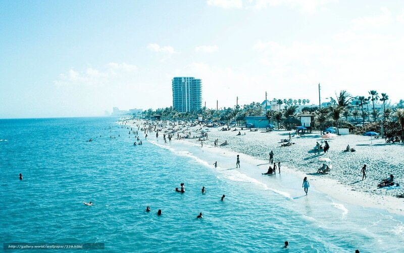 Beach scene with people and high-rise