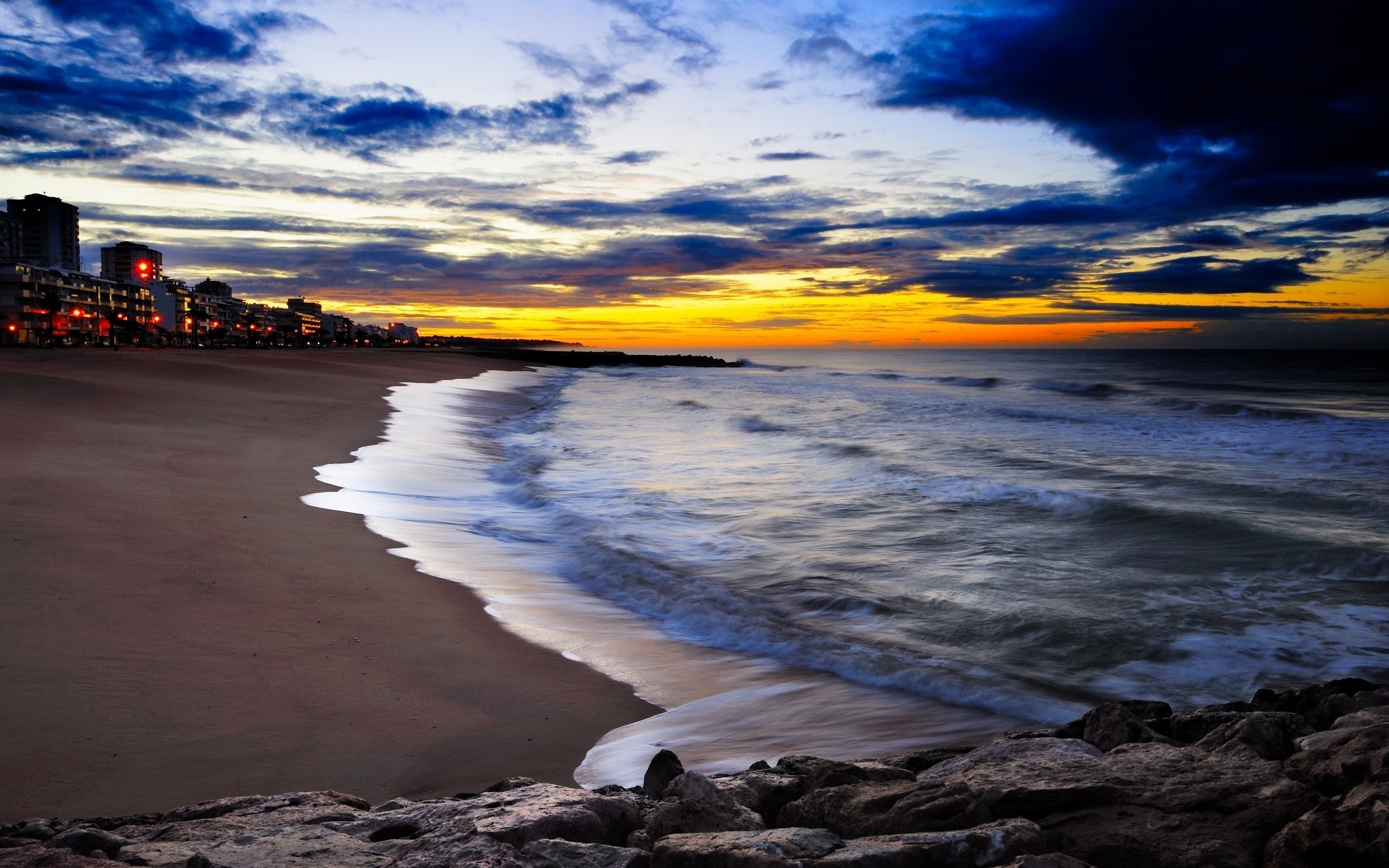 Beach sunset with city lights