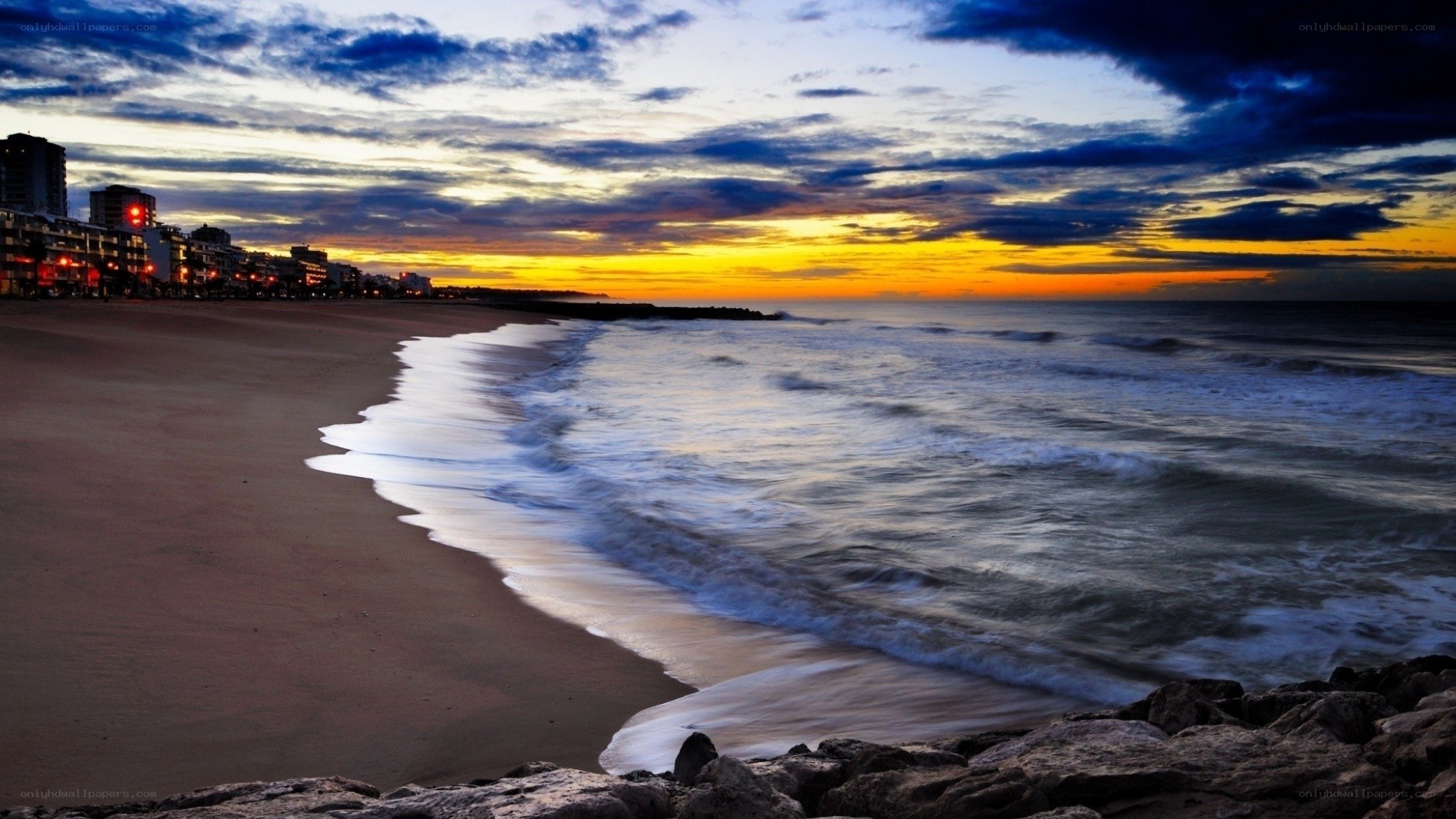 Beach sunset with city lights