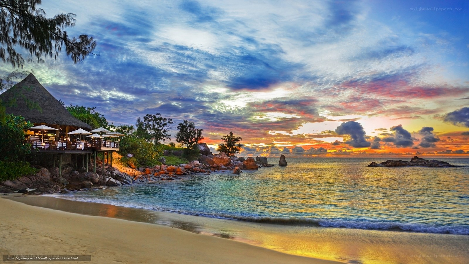 Beach sunset with thatched hut