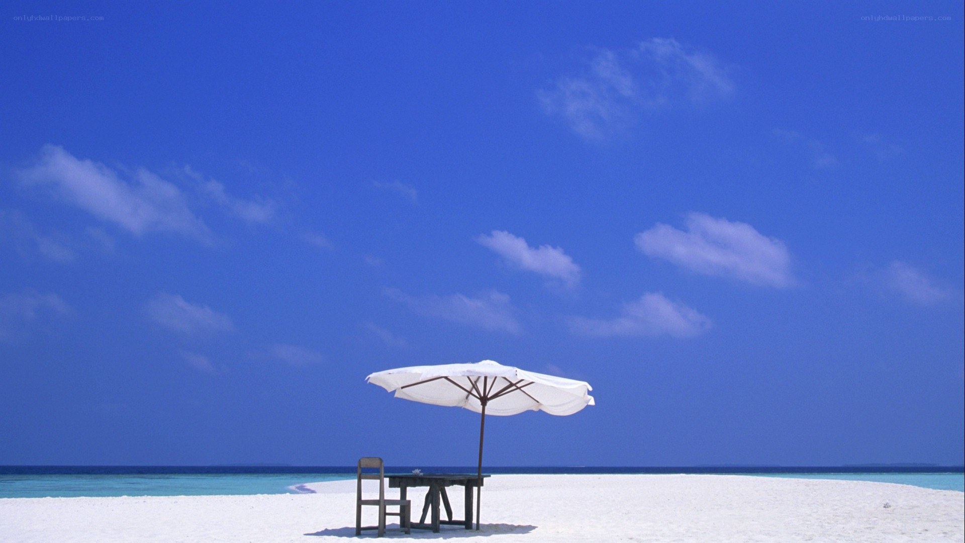 Beach umbrella on white sand