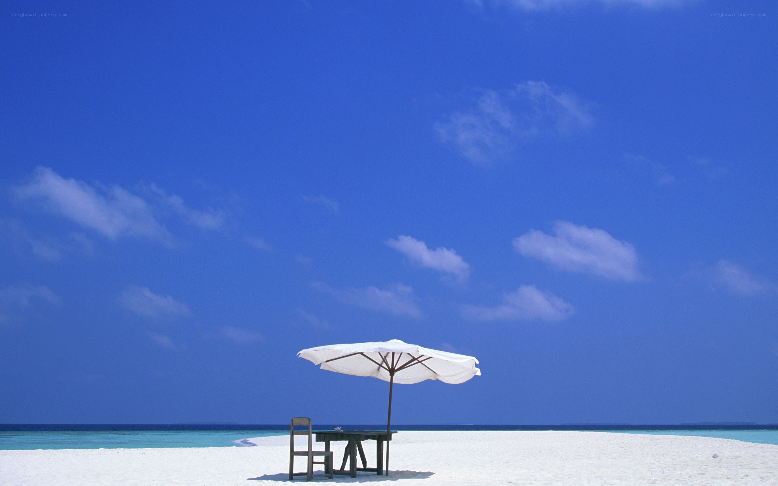 Beach umbrella on white sand
