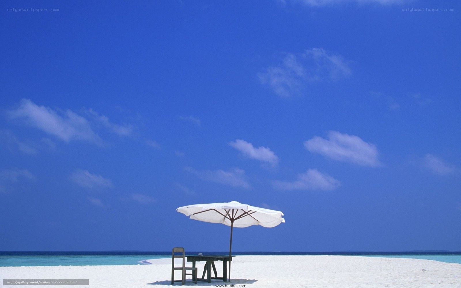 Beach umbrella on white sand