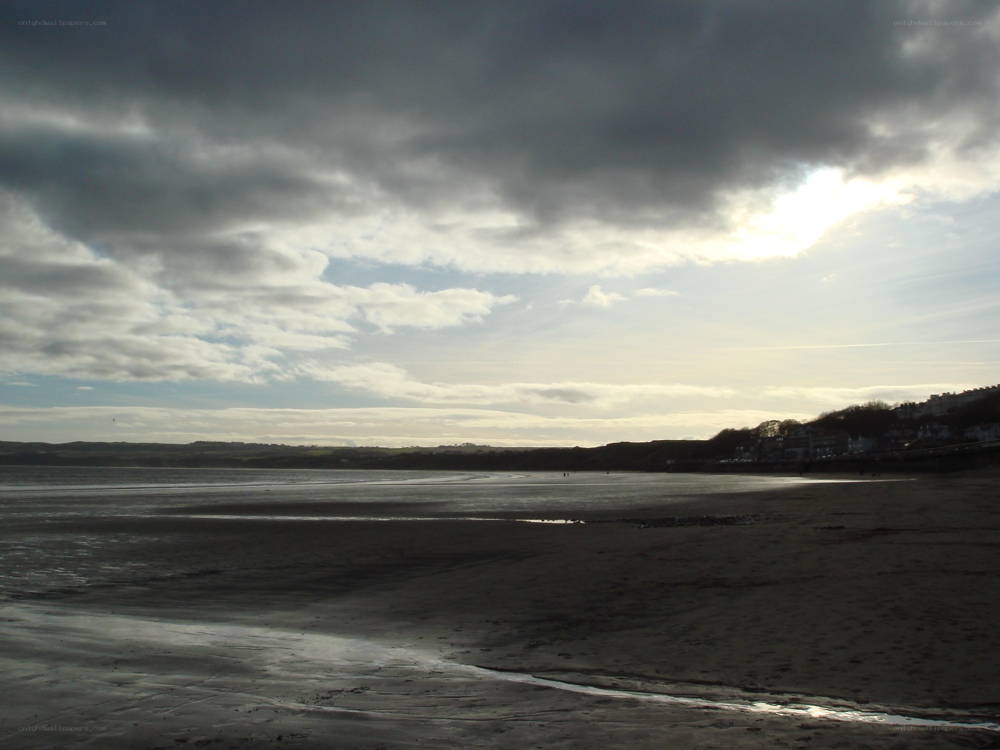 Beach under cloudy sky