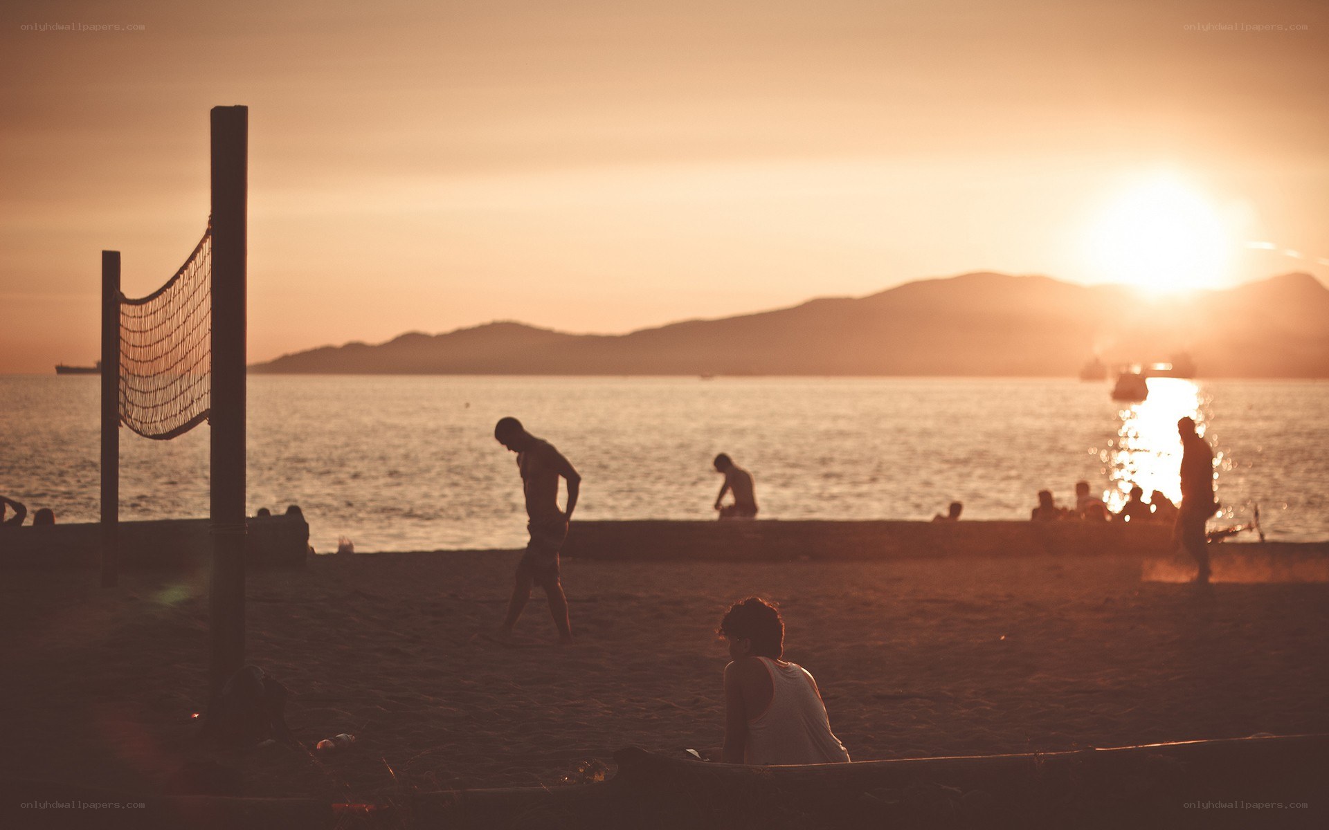 Beach volleyball at sunset